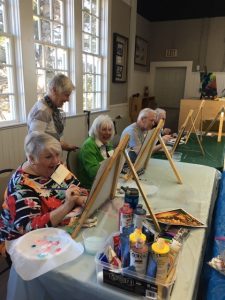 Students and volunteer in Aging Artfully program