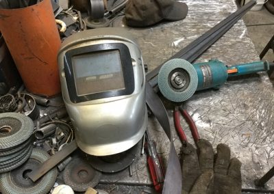 Nelson Shaw studio - welding helmet and grinder