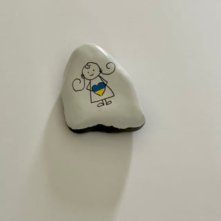 Dana Wagner - Rock Art - Girl holding yellow/blue heart - Dana Wagner - McMillan Arts Centre Gallery, Gift Shop and Box Office - Vancouver Island Art Gallery